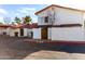 Exterior view of a two-story home with a red tile roof, showing private patios and reserved parking at 2842 E Beck Ln # 2, Phoenix, AZ 85032