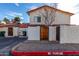 Exterior view of a two-story home with a red tile roof, showing private patios and reserved parking spaces at 2842 E Beck Ln # 2, Phoenix, AZ 85032