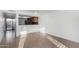 Open-concept living area showing the tile flooring with view of kitchen and sliding glass doors at 2842 E Beck Ln # 2, Phoenix, AZ 85032