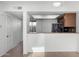 View from living room to kitchen showing stainless steel appliances, breakfast bar, and pantry at 2842 E Beck Ln # 2, Phoenix, AZ 85032