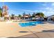 Community pool with clear blue water, easy access steps, and surrounding residential buildings under a sunny sky at 2842 E Beck Ln # 2, Phoenix, AZ 85032