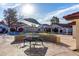 Community pool with a seating area, sunshade, and clear blue water, surrounded by lush landscaping at 2842 E Beck Ln # 2, Phoenix, AZ 85032