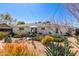 The large backyard features desert plants, with a patio set beneath an umbrella at 2902 E Avalon Dr, Phoenix, AZ 85016