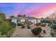 Expansive backyard featuring desert landscaping, a patio with dining set, and an open yard at 2902 E Avalon Dr, Phoenix, AZ 85016