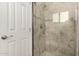 Bathroom shower with white-tiled enclosure at 2902 E Avalon Dr, Phoenix, AZ 85016