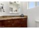 Bathroom featuring granite countertops, custom wood cabinetry, and framed mirror at 2902 E Avalon Dr, Phoenix, AZ 85016