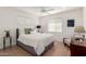 Bright bedroom with a ceiling fan, light-colored walls, and tiled floors at 2902 E Avalon Dr, Phoenix, AZ 85016