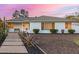 Charming single-story home boasting a landscaped front yard with desert plants and a stone walkway under a vivid sunset sky at 2902 E Avalon Dr, Phoenix, AZ 85016
