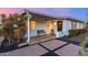 Quaint home with a covered front porch, comfortable bench, and desert-style landscaping at 2902 E Avalon Dr, Phoenix, AZ 85016