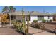 Charming home with desert landscaping featuring saguaro cacti and a lush bush at 2902 E Avalon Dr, Phoenix, AZ 85016