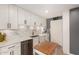 Charming kitchen with white cabinets, marble backsplash, quartz countertops, and stainless steel appliances at 2902 E Avalon Dr, Phoenix, AZ 85016