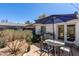 Backyard patio features desert plants and a table beneath a patio umbrella at 2902 E Avalon Dr, Phoenix, AZ 85016
