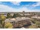 Aerial view of modern apartment complex showing lush trees and city views at 2989 N 44Th St # 3016, Phoenix, AZ 85018
