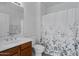 Bathroom featuring a single sink vanity and a shower with a floral curtain at 2989 N 44Th St # 3016, Phoenix, AZ 85018