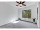 A naturally lit bedroom with large window, ceiling fan and neutral tones provide a serene and inviting atmosphere at 2989 N 44Th St # 3016, Phoenix, AZ 85018