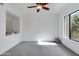 A naturally lit bedroom with large window, ceiling fan and neutral tones provide a serene and inviting atmosphere at 2989 N 44Th St # 3016, Phoenix, AZ 85018