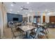 Well-lit common room featuring comfortable seating, a large TV, and ample table space for community activities at 2989 N 44Th St # 3016, Phoenix, AZ 85018