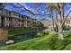 Beautiful water feature and landscaping, with trees, grass, and apartment building in background at 2989 N 44Th St # 3016, Phoenix, AZ 85018
