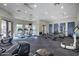 Community gym has a variety of cardio equipment, weight machines, and a view of the lush greenery outside at 2989 N 44Th St # 3016, Phoenix, AZ 85018
