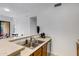 Bright kitchen featuring a breakfast bar and stainless steel double basin sink at 2989 N 44Th St # 3016, Phoenix, AZ 85018