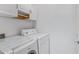 Bright laundry room with Bosch washer and dryer units and white cabinets above at 2989 N 44Th St # 3016, Phoenix, AZ 85018