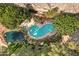 Aerial view of a beautiful pool and spa surrounded by lush landscaping and mature trees at 2989 N 44Th St # 3016, Phoenix, AZ 85018