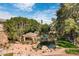 Community pool with a covered pavilion, lush landscaping, and lounge chairs at 2989 N 44Th St # 3016, Phoenix, AZ 85018