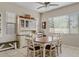 Bright dining area with ceiling fan, white table and chairs, and a charming hutch at 3117 E Sagebrush St, Gilbert, AZ 85296