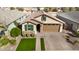 Beautiful home featuring a tile roof, green shutters, stone accents, and a two-car garage at 35207 N Agua Caliente Rd, San Tan Valley, AZ 85144