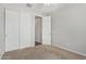 Bedroom featuring closet with sliding doors, neutral carpet, and entry door at 35207 N Agua Caliente Rd, San Tan Valley, AZ 85144