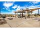 Community pavilion with picnic tables and a grill area for outdoor gatherings and relaxation at 35207 N Agua Caliente Rd, San Tan Valley, AZ 85144