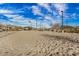 Community sand volleyball court with net and surrounding landscape, perfect for outdoor sports and recreation at 35207 N Agua Caliente Rd, San Tan Valley, AZ 85144