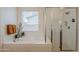 Bright bathroom featuring a soaking tub with tiled surround and a glass-enclosed shower at 3563 E Austin Dr, Gilbert, AZ 85296