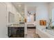 Bathroom vanity with granite countertop, dark cabinets, and view into the bedroom at 3563 E Austin Dr, Gilbert, AZ 85296