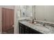 Bathroom featuring double sink vanity with granite counters and pink patterned shower curtain at 3563 E Austin Dr, Gilbert, AZ 85296