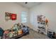 bedroom featuring a bed, window, shelving unit, and personal decorations at 3563 E Austin Dr, Gilbert, AZ 85296