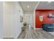 Bright hallway with wood floors, leading to a living area with a cozy blue couch at 3563 E Austin Dr, Gilbert, AZ 85296