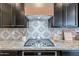 Close up of gourmet kitchen featuring granite countertops, stylish backsplash, and a gas range at 3563 E Austin Dr, Gilbert, AZ 85296