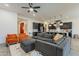 Open-concept living room with modern decor, dark-wood floors, and comfortable seating adjacent to the kitchen area at 3563 E Austin Dr, Gilbert, AZ 85296
