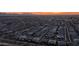 Expansive aerial view of a Primary-planned community showcasing the neighborhood layout with a stunning sunset backdrop at 40195 N Hailey Ln, Queen Creek, AZ 85140