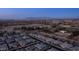 A wide-angle aerial view showing a Primary-planned community with well-maintained homes under a peaceful twilight sky at 40195 N Hailey Ln, Queen Creek, AZ 85140