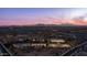 Aerial shot showcasing community recreational facilities, including tennis courts, a pool, and a clubhouse, all set against a mountain view at 40195 N Hailey Ln, Queen Creek, AZ 85140