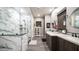 Beautiful bathroom featuring a marble shower, dual vanities, dark wood cabinets, and trendy fixtures at 40195 N Hailey Ln, Queen Creek, AZ 85140