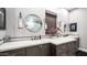 Stylish bathroom with dual sinks, white countertops, and dark wood cabinets, creating a spa-like retreat at 40195 N Hailey Ln, Queen Creek, AZ 85140