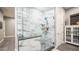 Modern bathroom with marble shower and glass enclosure, offers a sleek and luxurious design at 40195 N Hailey Ln, Queen Creek, AZ 85140