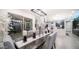 Open-concept dining area with stylish lighting, modern decor, and seamless flow to the kitchen and outdoor spaces at 40195 N Hailey Ln, Queen Creek, AZ 85140