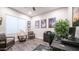 Well-lit home office featuring a large desk, comfortable seating, and themed decor at 40195 N Hailey Ln, Queen Creek, AZ 85140