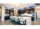 Gourmet kitchen featuring a large island with seating, stainless steel appliances, and modern lighting at 40195 N Hailey Ln, Queen Creek, AZ 85140