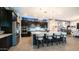 A gourmet kitchen featuring black cabinetry, stainless steel appliances, and a large island with bar stool seating at 40195 N Hailey Ln, Queen Creek, AZ 85140
