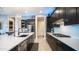 This well-appointed kitchen boasts black cabinetry, stainless appliances, and a central island with bar seating at 40195 N Hailey Ln, Queen Creek, AZ 85140